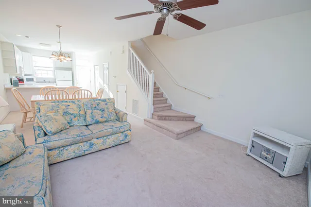 a spacious bedroom with a bed and a chandelier