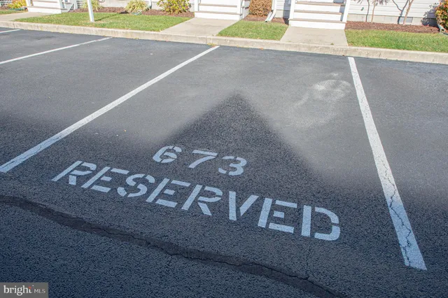 a sign broad in front of flowers