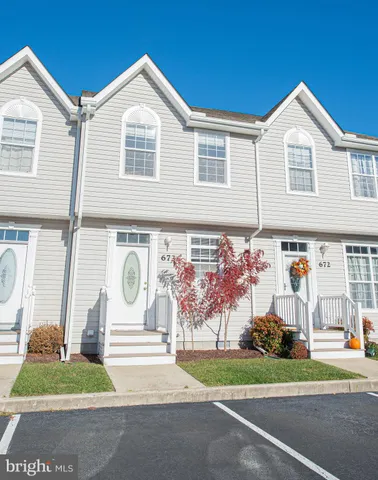 a kitchen with stainless steel appliances granite countertop a refrigerator sink and white cabinets