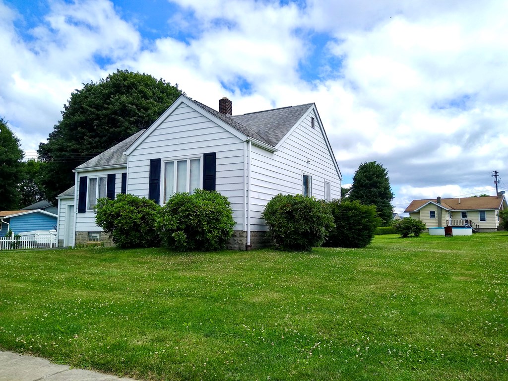 191 Baker Street Rimersburg, PA 16248 - Photo 2 of 13 a house that is sitting in the grass with large trees and plants