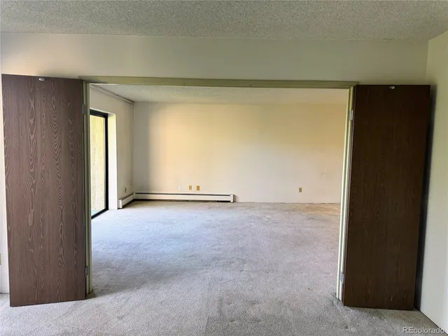 a view of an empty room and a window