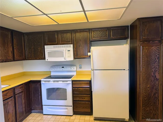 a kitchen with a refrigerator and a stove