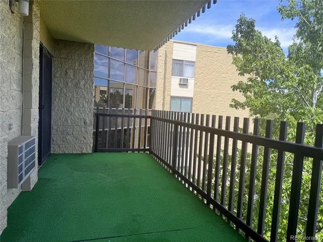 a view of a porch with wooden floor and fence