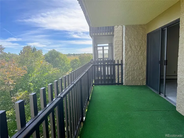 a view of a deck and mountains from a balcony