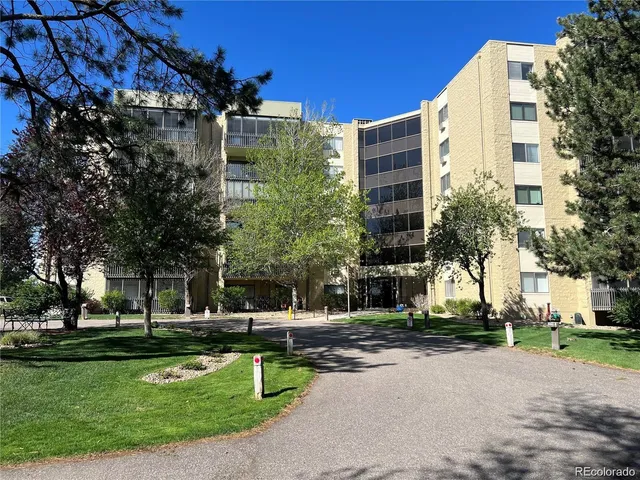 a front view of a building with trees
