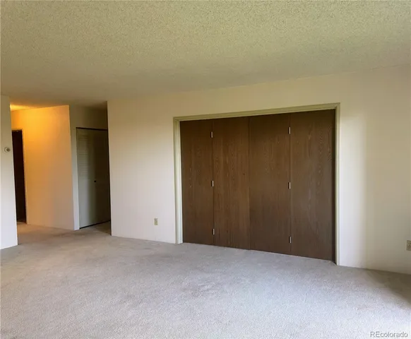 an empty room with closet area