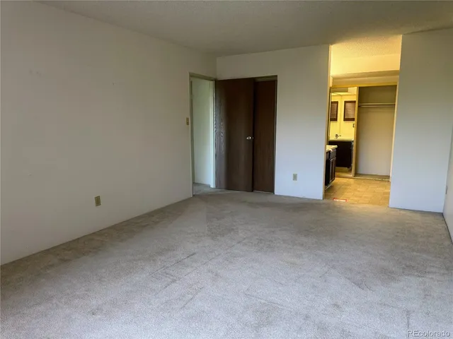a view of an empty room with glass door