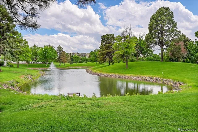 an aerial view of a house with a yard and lake view