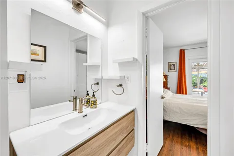 a en suite bathroom with a tub sink and mirror