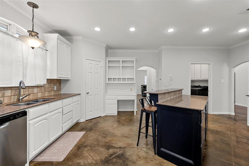 3696 Old Lorena Road Lorena, TX 76655 - Photo 10 of 27 Kitchen featuring white cabinetry, granite countertops, tile backsplash, stainless steel dishwasher, and a center island with a built-in breakfast bar