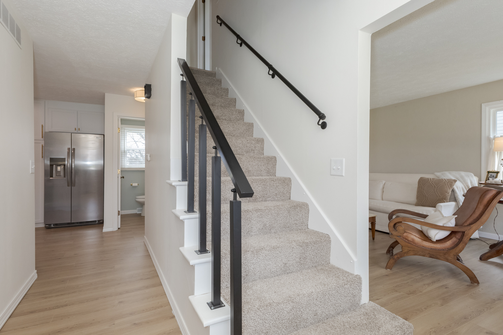 1805 Widermere Drive Normal, IL 61761 - Photo 20 of 46 a view of a hallway with wooden floor and staircase
