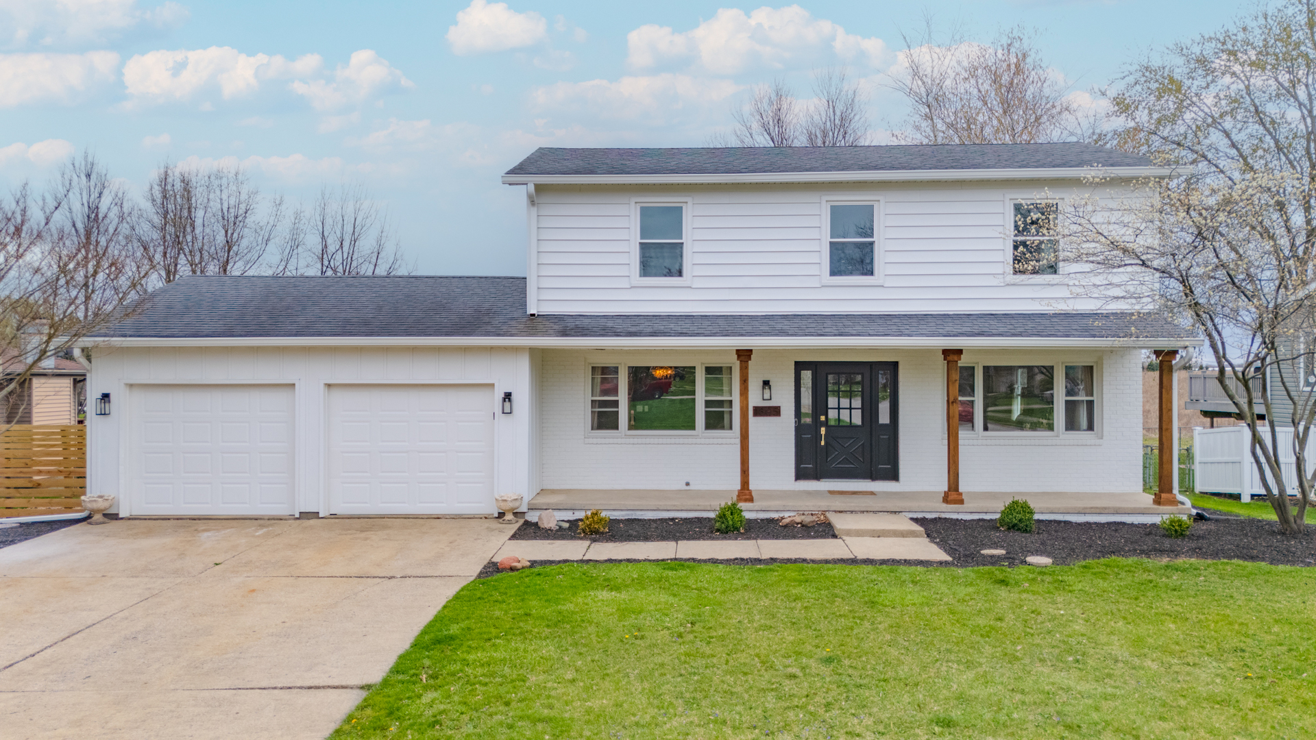 1805 Widermere Drive Normal, IL 61761 - Photo 2 of 46 a front view of a house with a yard garage and outdoor seating
