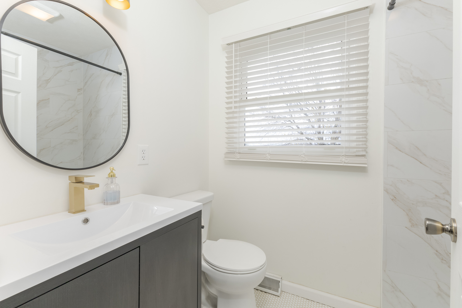 1805 Widermere Drive Normal, IL 61761 - Photo 25 of 46 a bathroom with a sink a mirror and a toilet