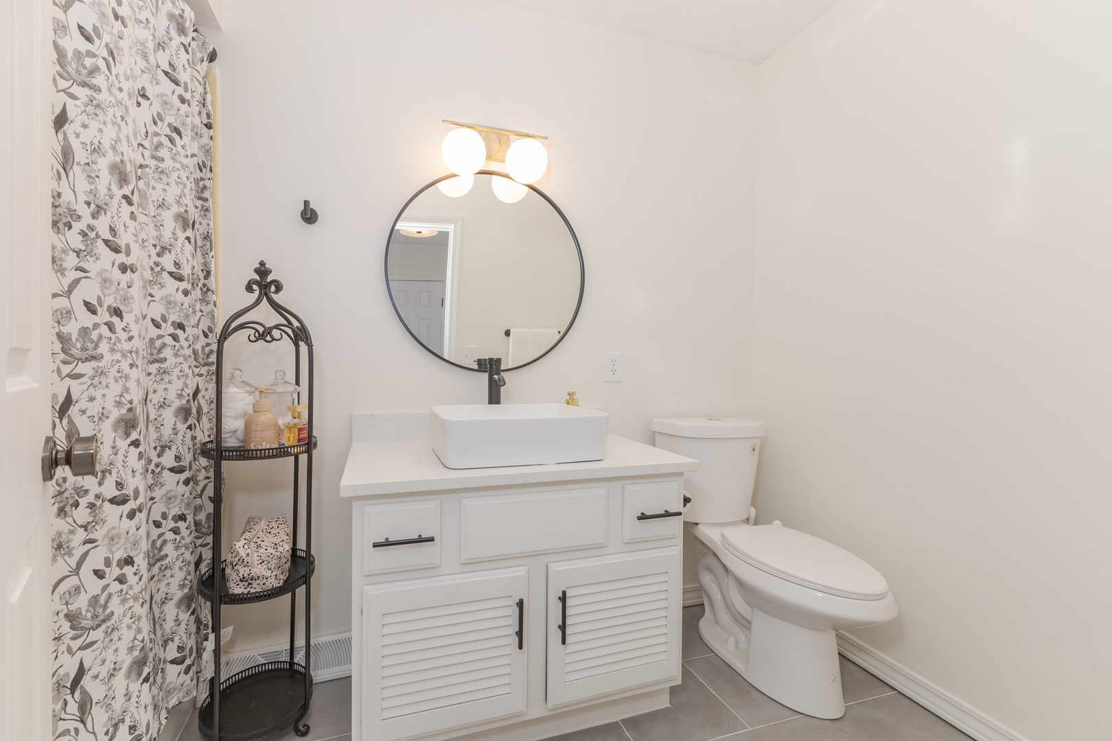 1805 Widermere Drive Normal, IL 61761 - Photo 31 of 46 a bathroom with a toilet sink vanity and mirror