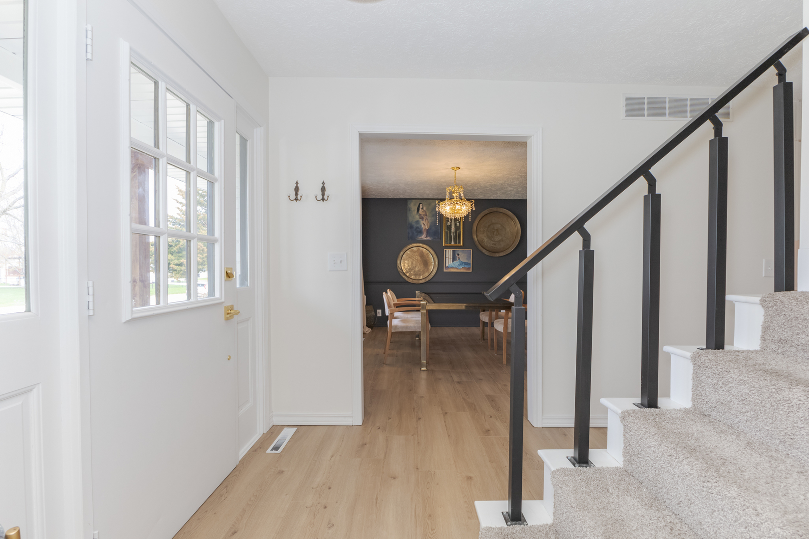 1805 Widermere Drive Normal, IL 61761 - Photo 6 of 46 a view of a hallway with wooden floor and staircase