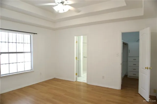 an empty room with windows and closet