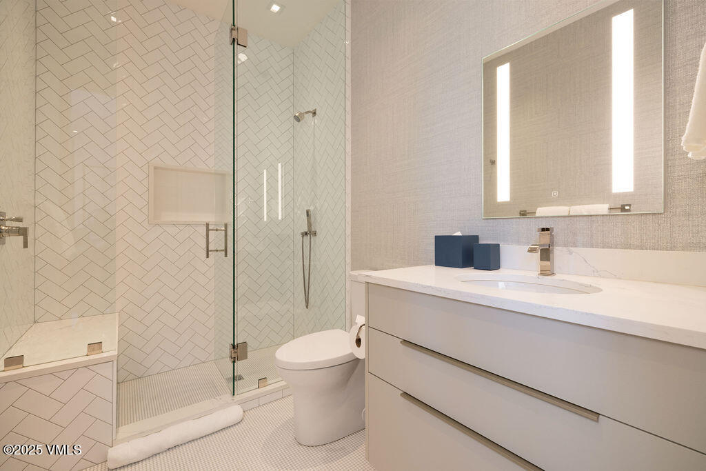 254 Beaver Dam Road Vail, CO 81657 - Photo 30 of 46 a bathroom with a sink a toilet and shower