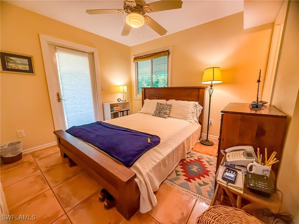 4511 Conch Shell Drive Upper Captiva, FL 33924 - Photo 11 of 50 a bedroom with a bed and wooden floor