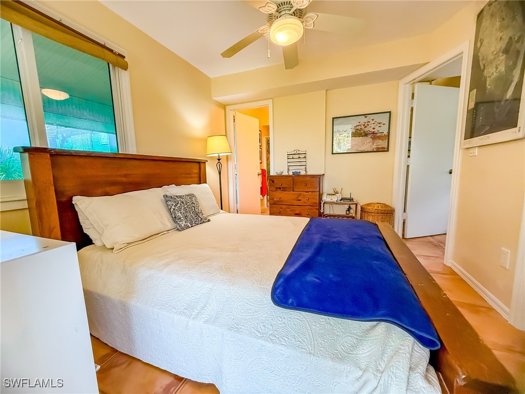 4511 Conch Shell Drive Upper Captiva, FL 33924 - Photo 17 of 50 a spacious bedroom with a bed and a painting on the wall