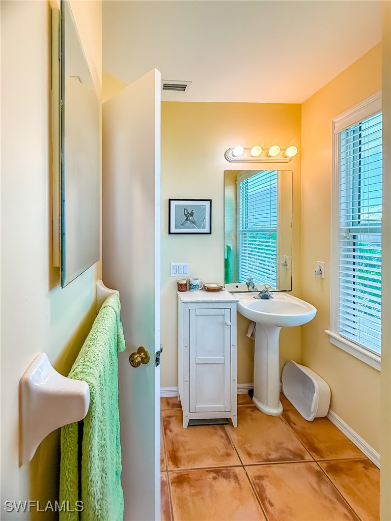 4511 Conch Shell Drive Upper Captiva, FL 33924 - Photo 21 of 50 a bathroom with a sink and a mirror