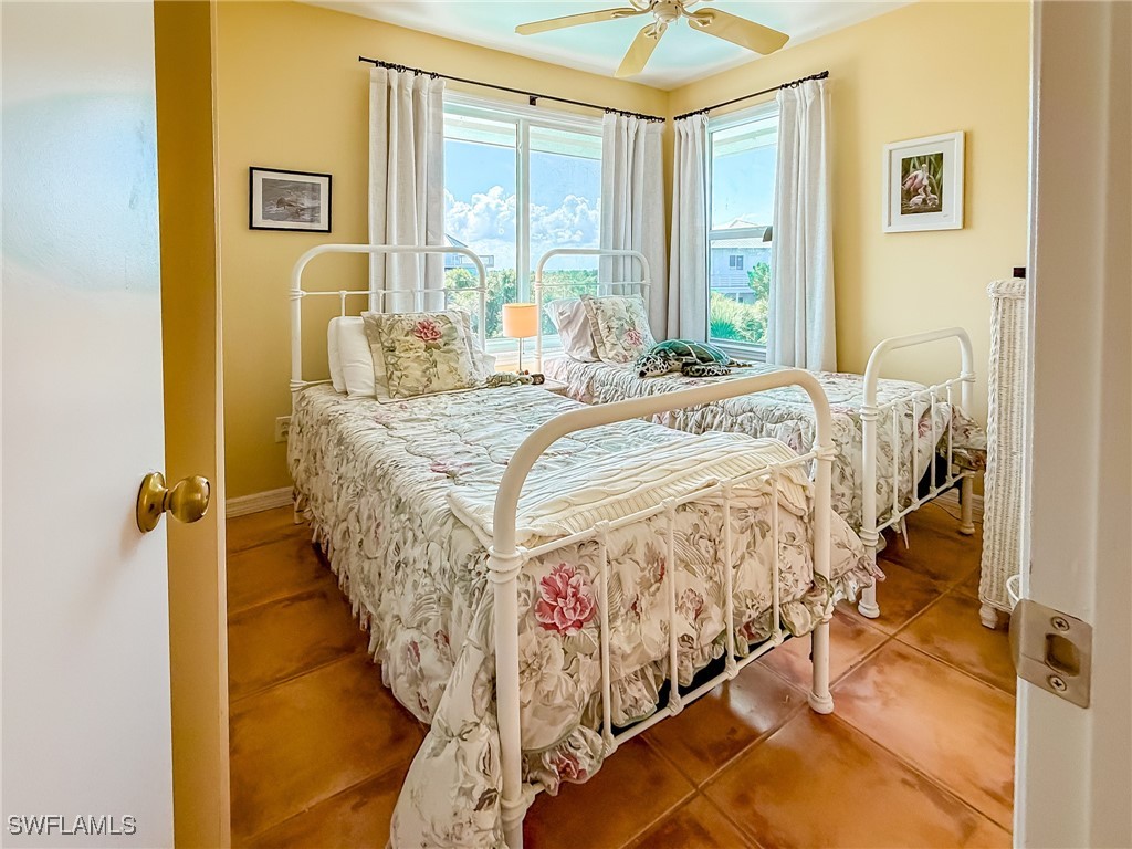 4511 Conch Shell Drive Upper Captiva, FL 33924 - Photo 23 of 50 a bed sitting in a bedroom next to a window