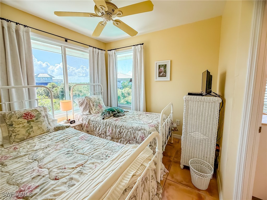 4511 Conch Shell Drive Upper Captiva, FL 33924 - Photo 24 of 50 a bedroom with a bed and a window