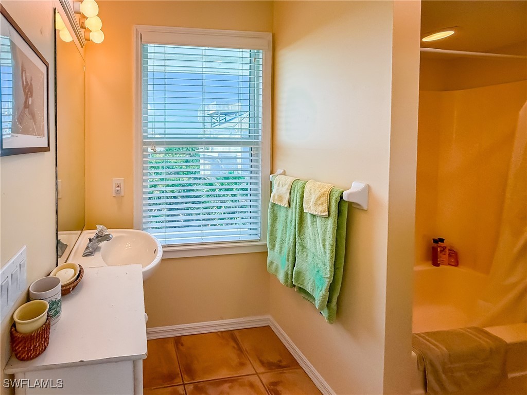 4511 Conch Shell Drive Upper Captiva, FL 33924 - Photo 25 of 50 a bathroom with a sink and bathtub