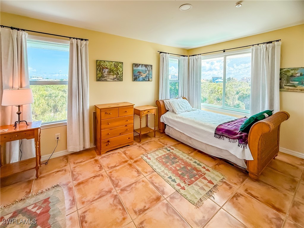 4511 Conch Shell Drive Upper Captiva, FL 33924 - Photo 28 of 50 a bedroom with a bed and a couch