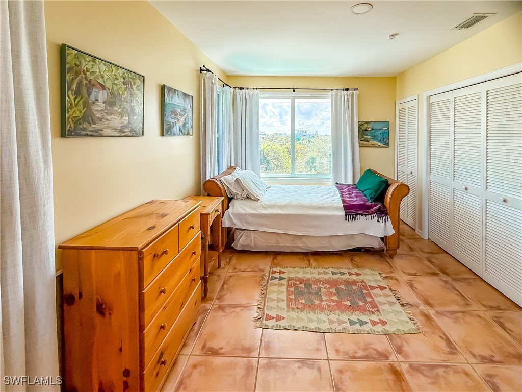 4511 Conch Shell Drive Upper Captiva, FL 33924 - Photo 29 of 50 a bedroom with a bed and a window