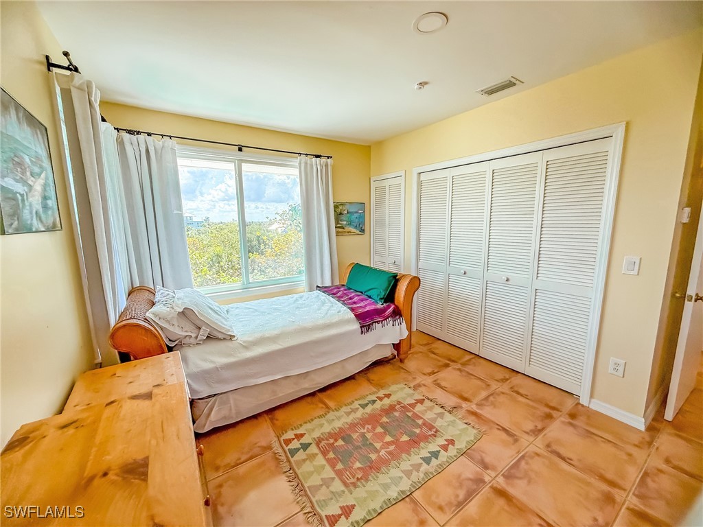 4511 Conch Shell Drive Upper Captiva, FL 33924 - Photo 30 of 50 a bed sitting in a bedroom next to a window
