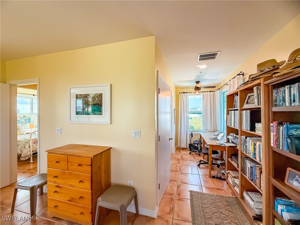 4511 Conch Shell Drive Upper Captiva, FL 33924 - Photo 32 of 50 a living room with furniture and a book shelf