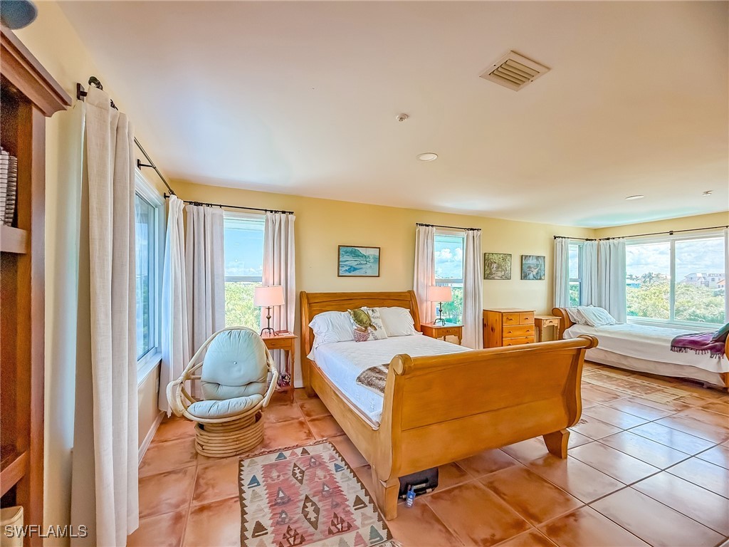 4511 Conch Shell Drive Upper Captiva, FL 33924 - Photo 33 of 50 a bed room with a bed and a couch