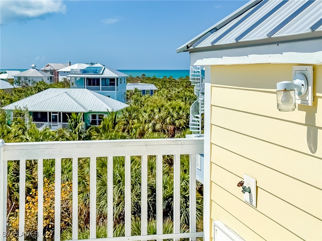 4511 Conch Shell Drive Upper Captiva, FL 33924 - Photo 42 of 50 a view of a porch with furniture and a small yard