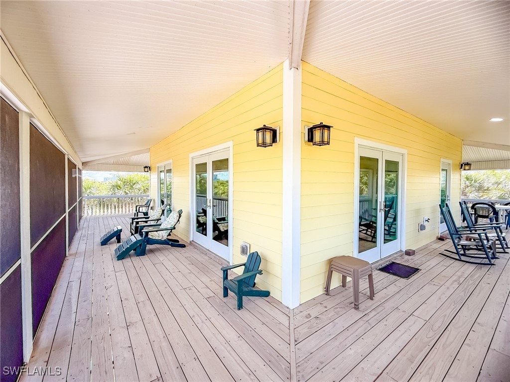 4511 Conch Shell Drive Upper Captiva, FL 33924 - Photo 44 of 50 a balcony with wooden floor and furniture