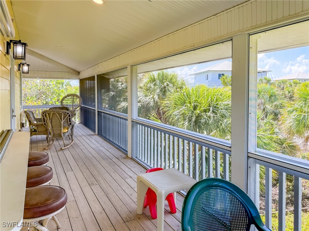 4511 Conch Shell Drive Upper Captiva, FL 33924 - Photo 45 of 50 a view of a balcony with furniture and wooden floor