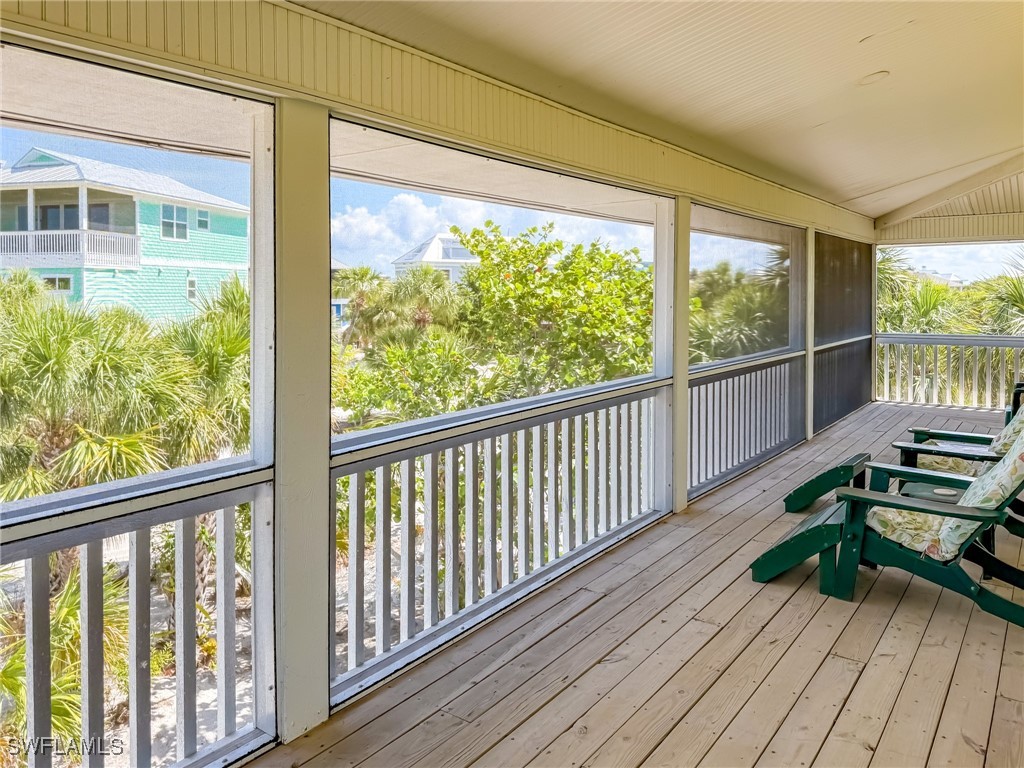4511 Conch Shell Drive Upper Captiva, FL 33924 - Photo 47 of 50 a view of a balcony with chair and wooden floor
