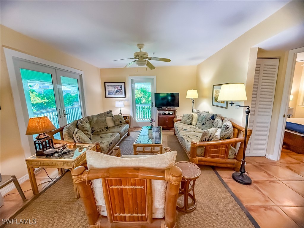 4511 Conch Shell Drive Upper Captiva, FL 33924 - Photo 10 of 50 a living room with a couch and a chandelier