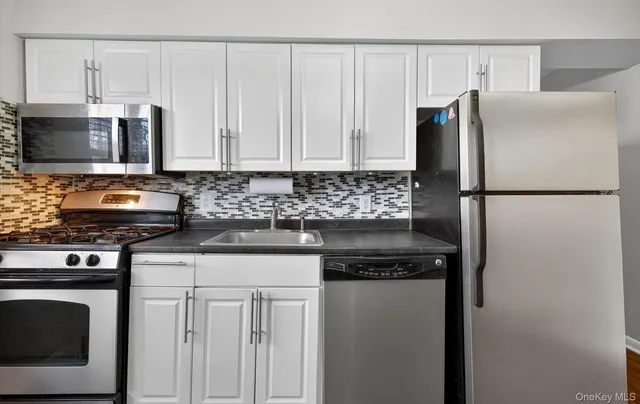 a kitchen with a refrigerator stove and microwave