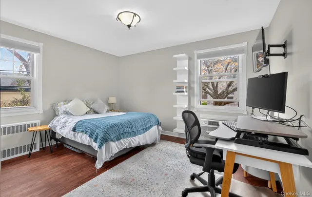 a bedroom with a bed and a desk