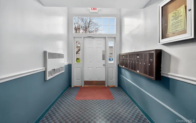 a room with painting and a lamp