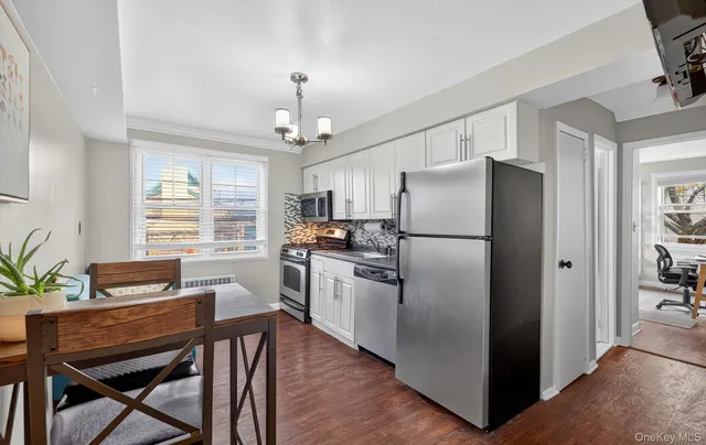 a kitchen with refrigerator cabinets dining table and chairs