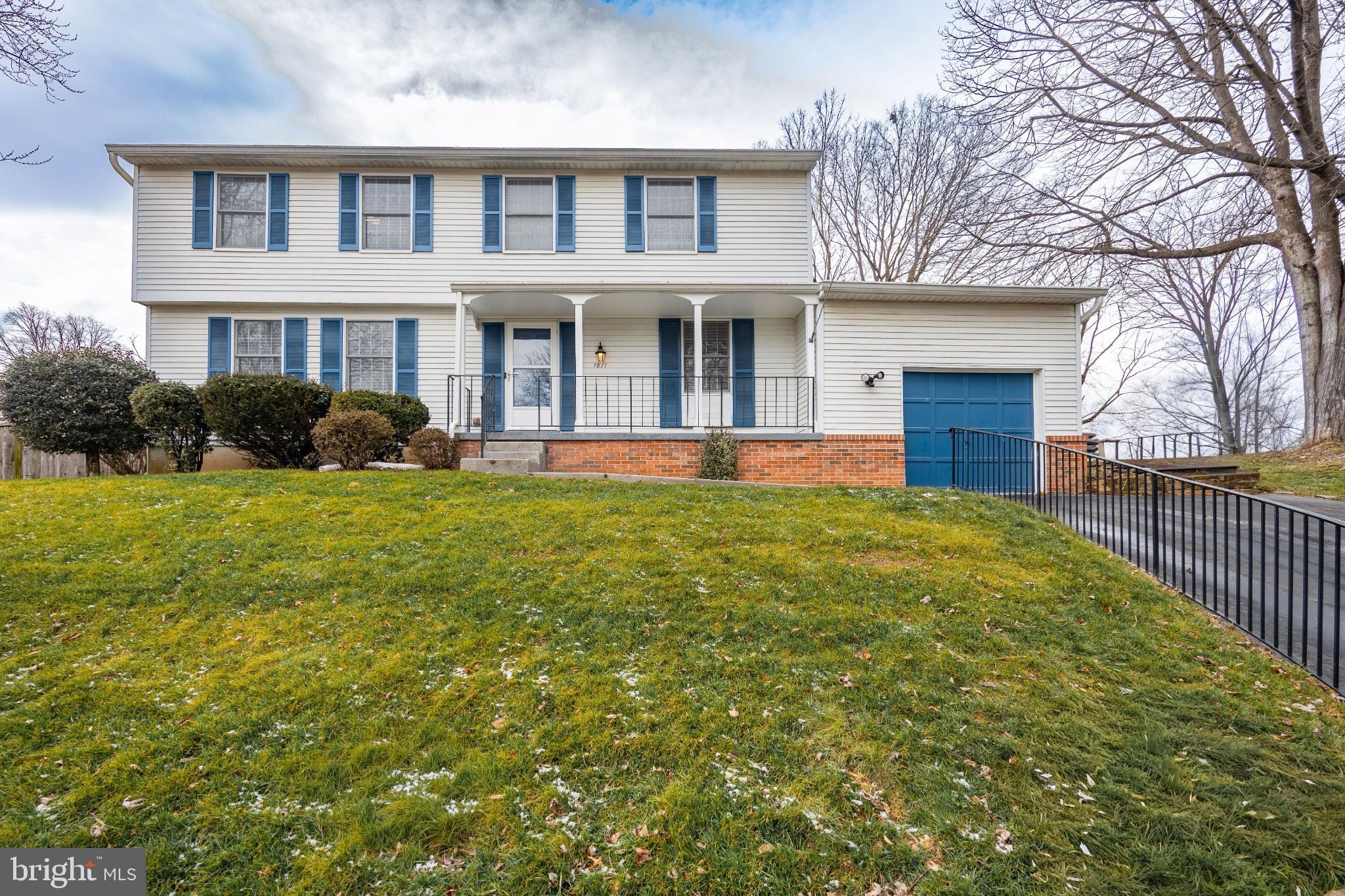 1811 Rustic Hill Court Frederick, MD 21702 - Photo 1 of 48 a front view of a house with yard and green space