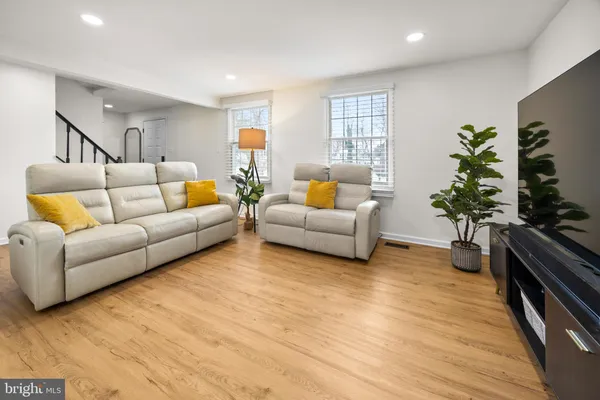 a living room with furniture and a potted plant