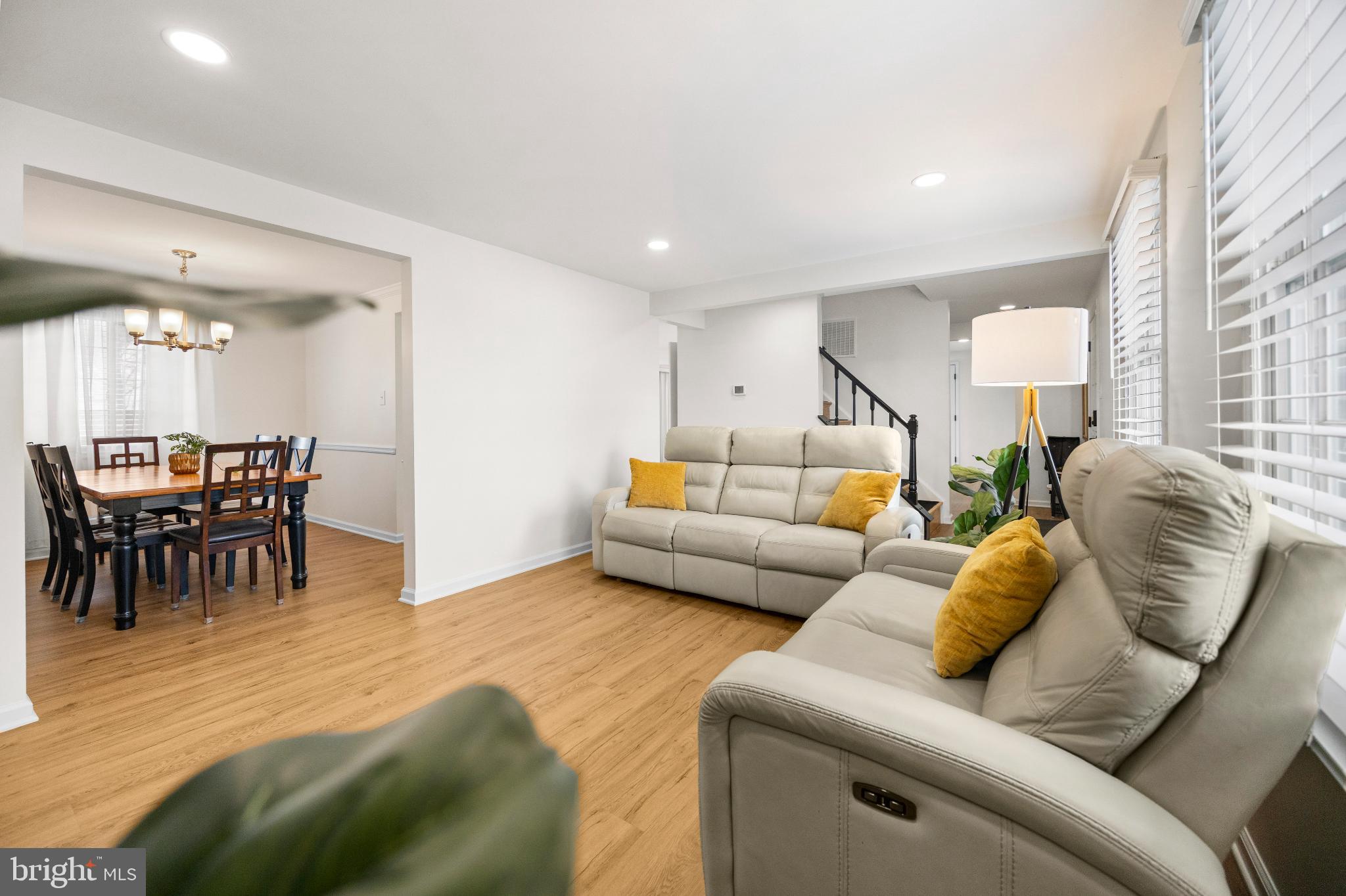 1811 Rustic Hill Court Frederick, MD 21702 - Photo 12 of 48 a living room with furniture and a dining table with kitchen view