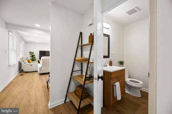 a view of living room with furniture and wooden floor