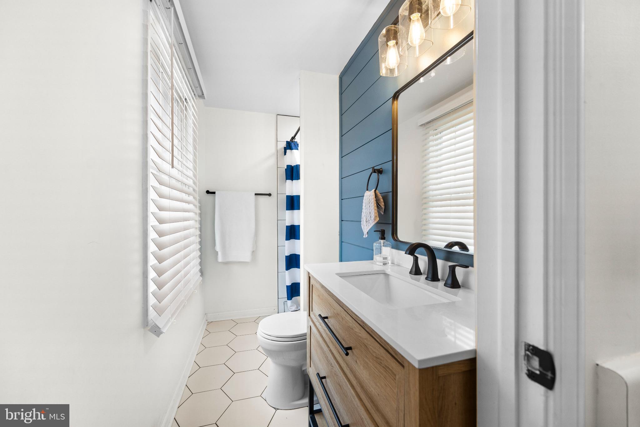 1811 Rustic Hill Court Frederick, MD 21702 - Photo 18 of 48 a bathroom with a sink a toilet a mirror and shower