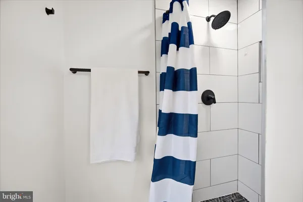 a bathroom with a shower and a mirror