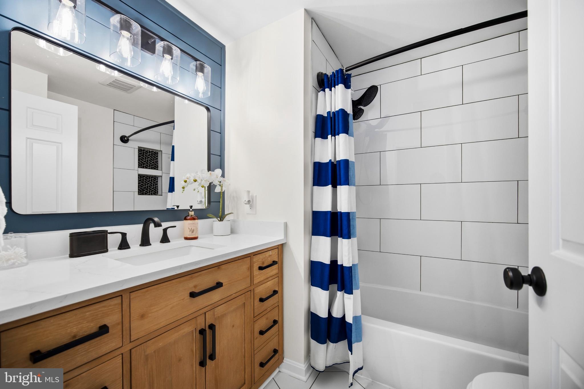 1811 Rustic Hill Court Frederick, MD 21702 - Photo 23 of 48 a bathroom with a bathtub sink vanity and mirror
