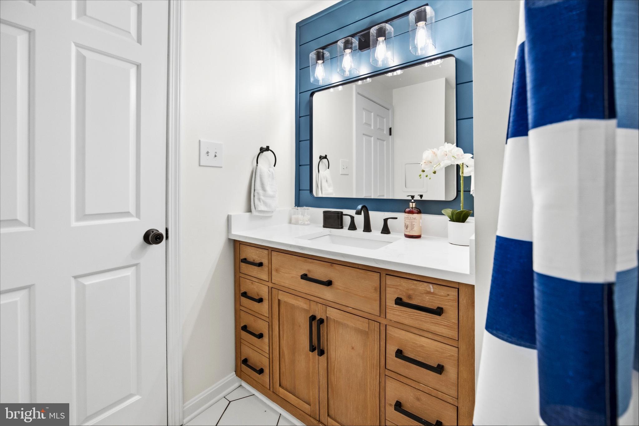 1811 Rustic Hill Court Frederick, MD 21702 - Photo 25 of 48 a bathroom with a sink vanity and mirror