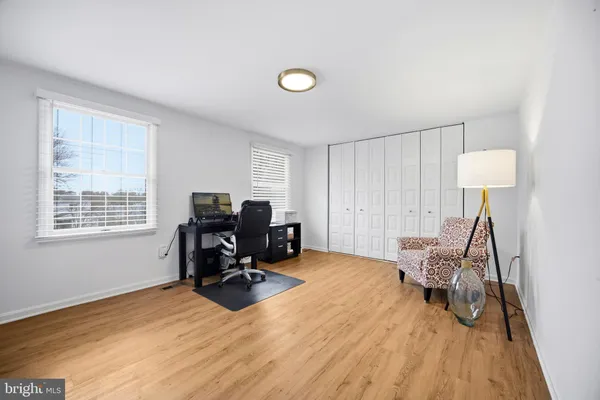 a view of a workspace with furniture and a window